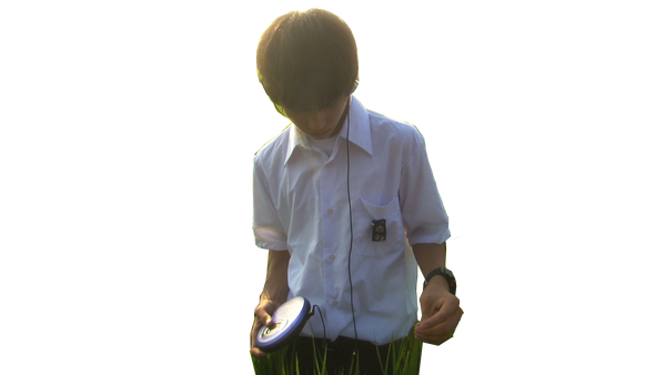 A listener standing in a green rice field